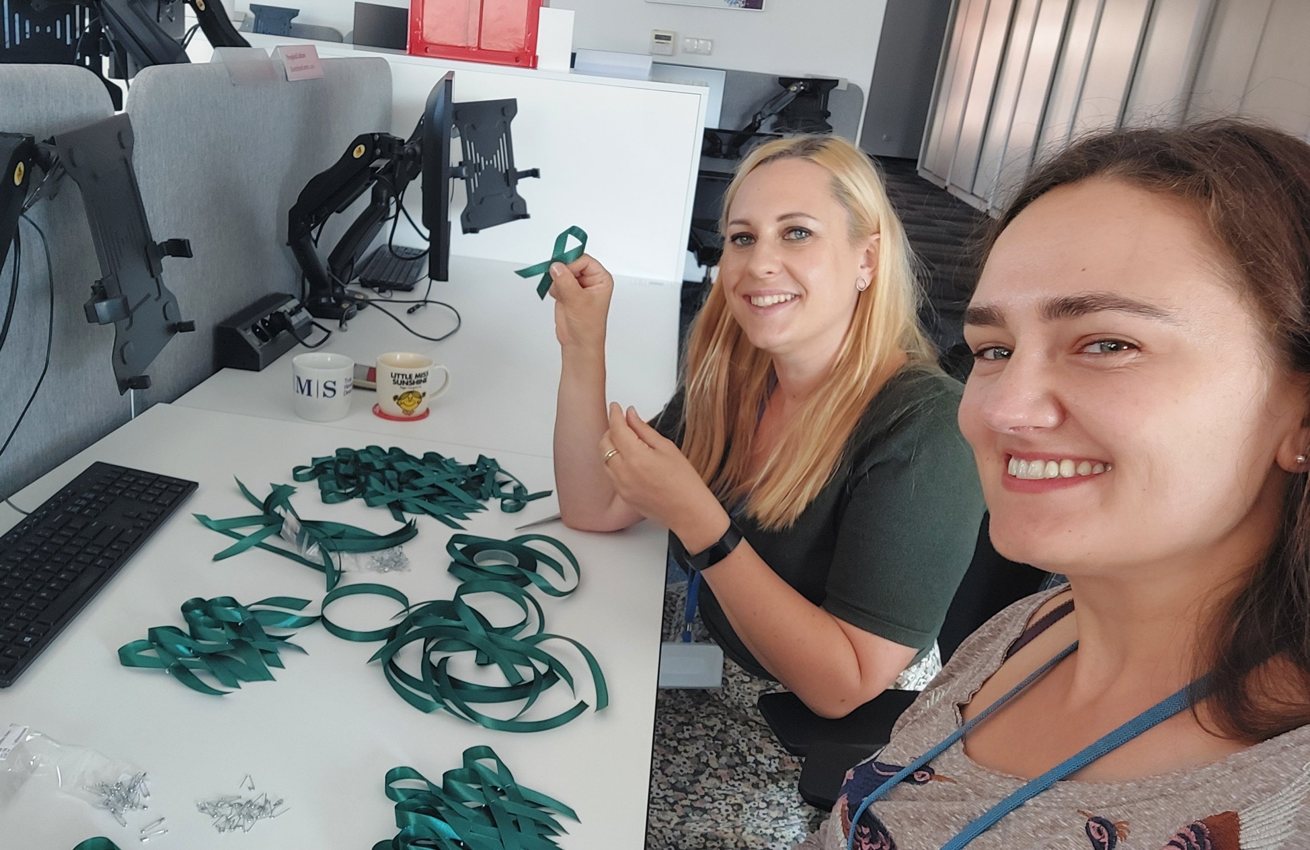Two AMS employees in Belfast prepare support ribbons during an office-wide community service effort