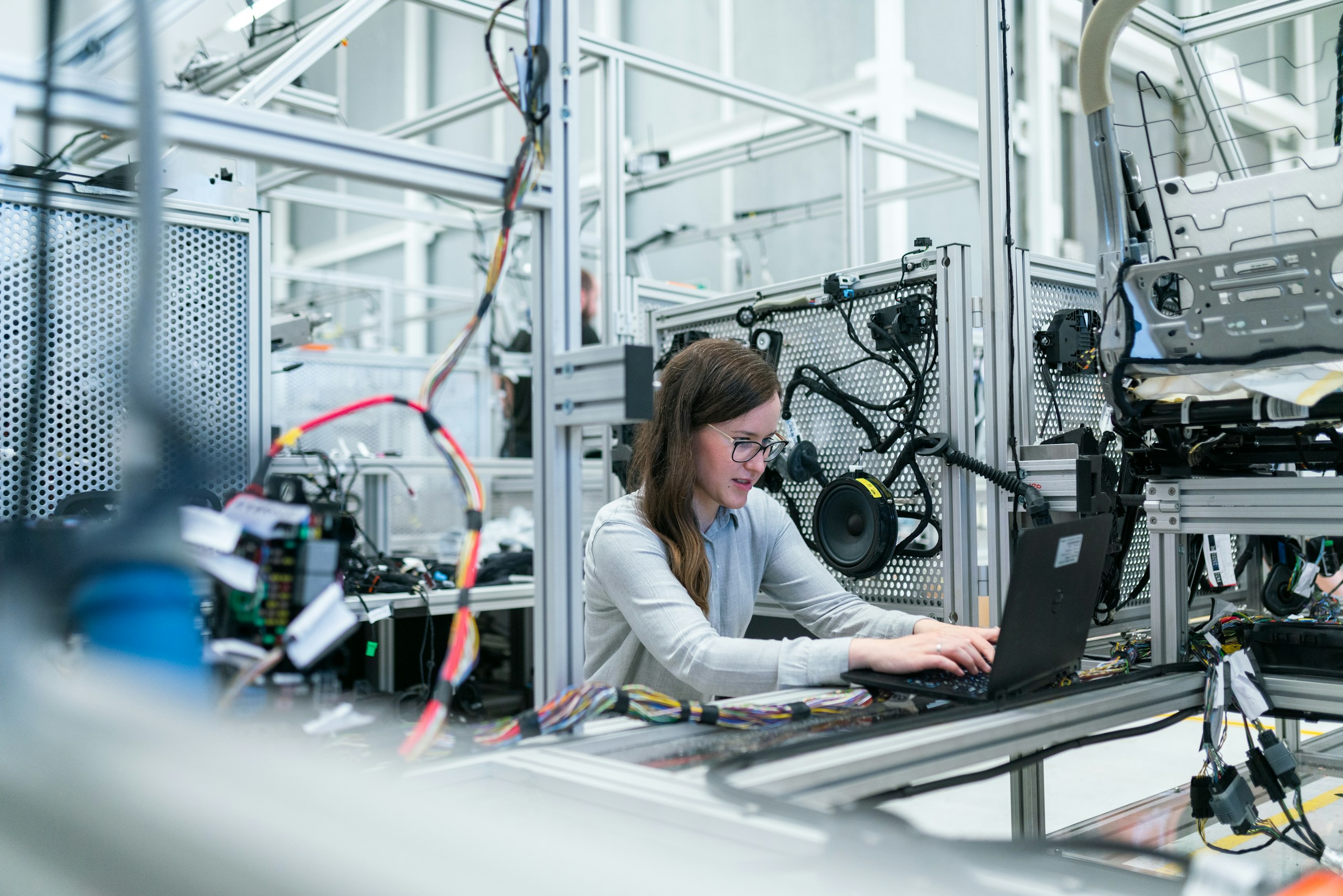 Female electronics engineer working in factory