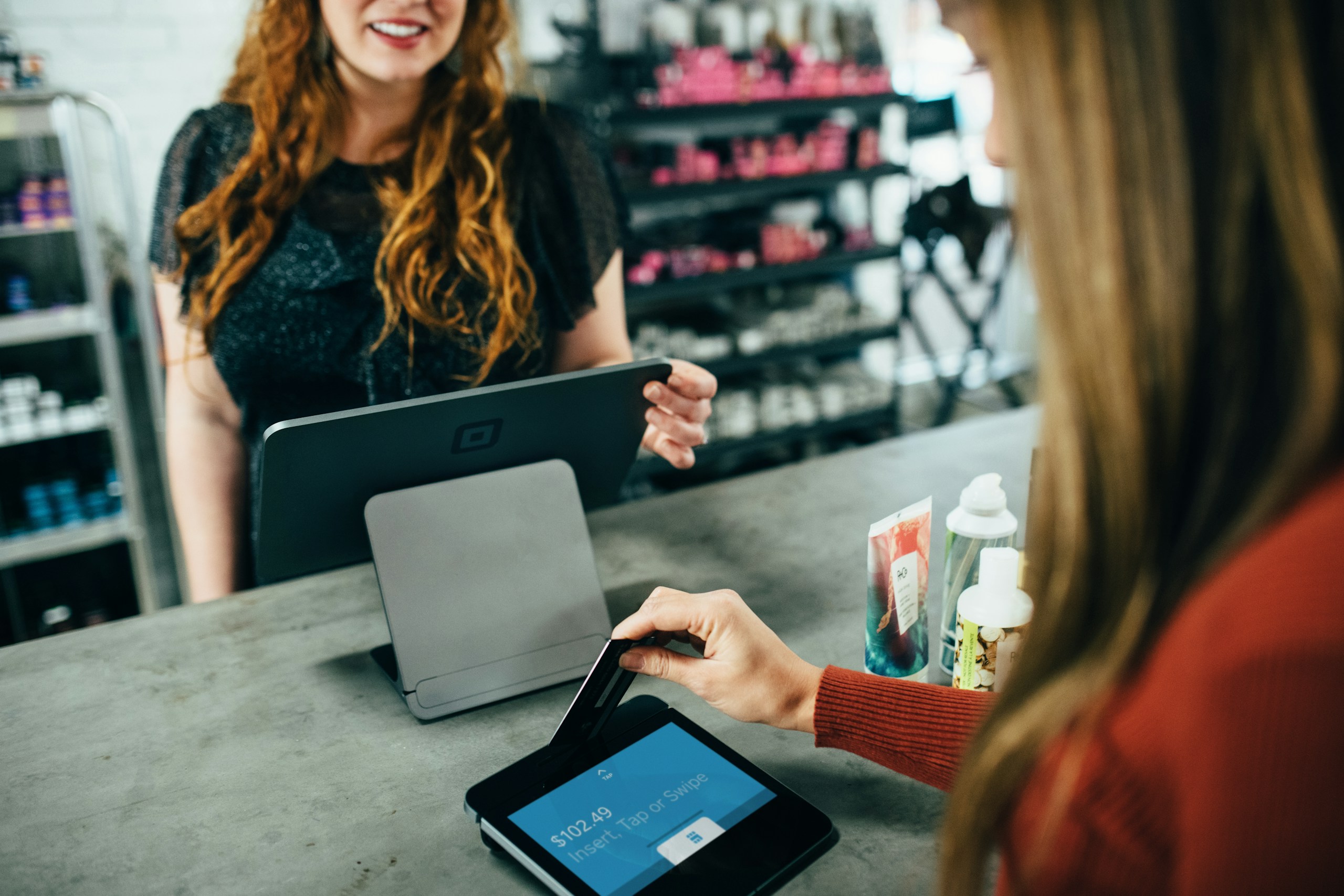 woman holding magnetic card - showing retail environment